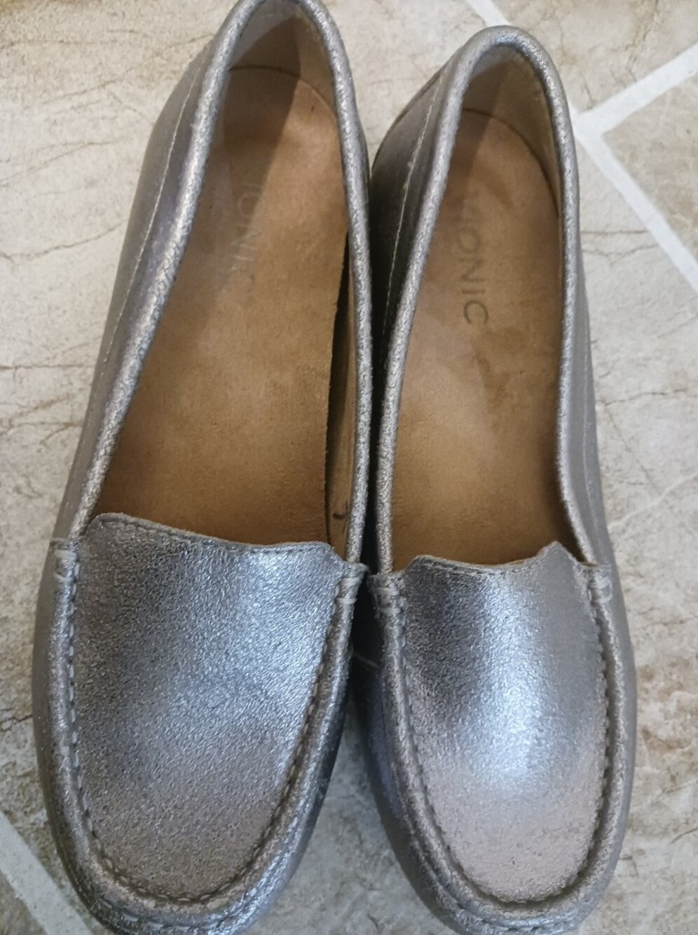 Two pairs of moccasins vionic debbie .One bronze and the other silver.